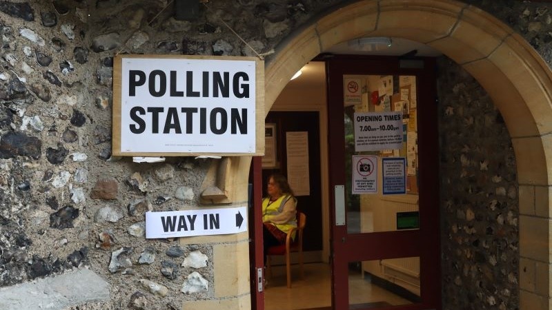 Picture shows entrance to a polling station. Two signs, with the words Polling Station and Way In.