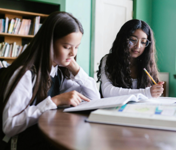 Image of two girls reading.