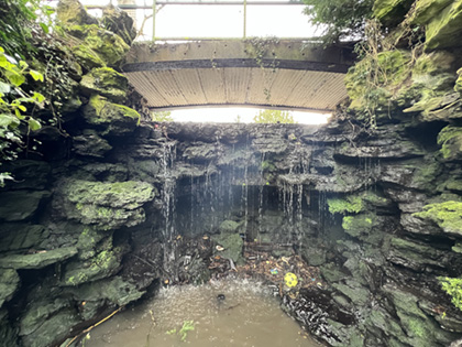 The historic waterfall, a rocky cascade with water flowing from the Upper Lake down to the Lower Lake.