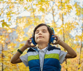 Image of a young boy with headphones on.